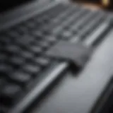 Close-up of a MacBook keyboard being cleaned with a microfiber cloth